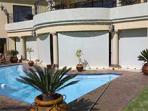 Beige gear operated roller blinds